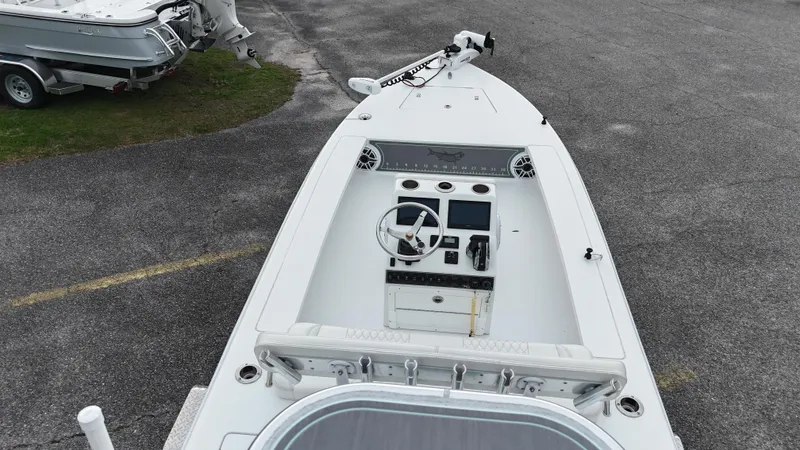 Slide: The Image of 2023 Vtech 18 boat, white interior, steering console, parked on asphalt. - 13