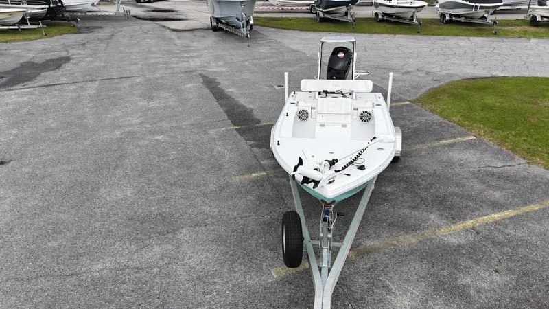 Slide: The Image of A 2023 Vtech 18 boat on a trailer in a parking lot. - 5