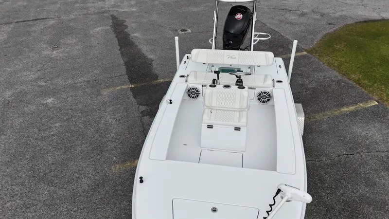 Slide: The Image of 2023 Vtech 18 boat, aerial view, white deck, motor, and seating. - 6