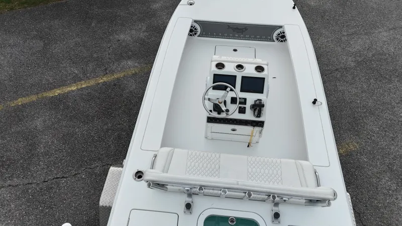 Slide: The Image of Aerial view of a 2023 Vtech 18 boat's control panel and seating area. - 9