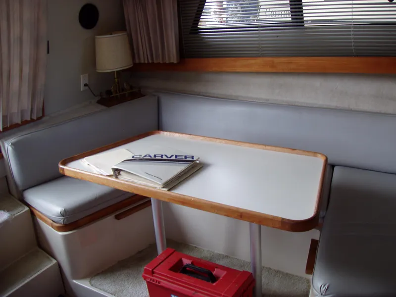 Slide: The Image of Interior of 1990 Carver Mariner 32 yacht with dining table and seating area. - 14