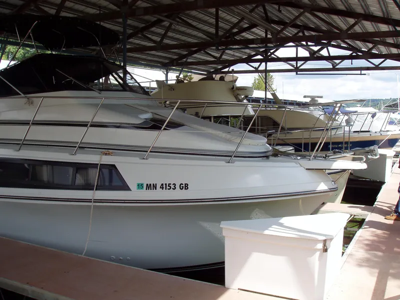 Slide: The Image of 1990 Carver Mariner 32 docked in a covered marina. - 17