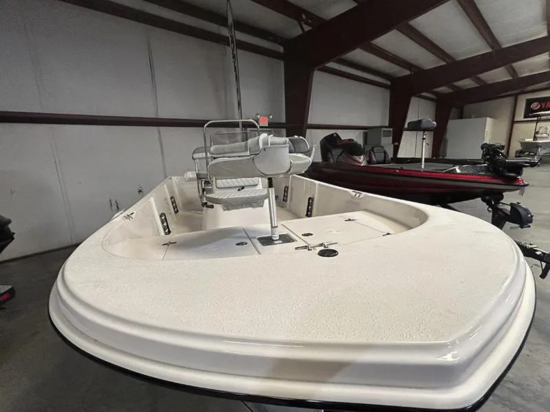 Slide: The Image of 2024 Carolina Skiff 192 JLS boat in indoor showroom, showcasing spacious deck design. - 3