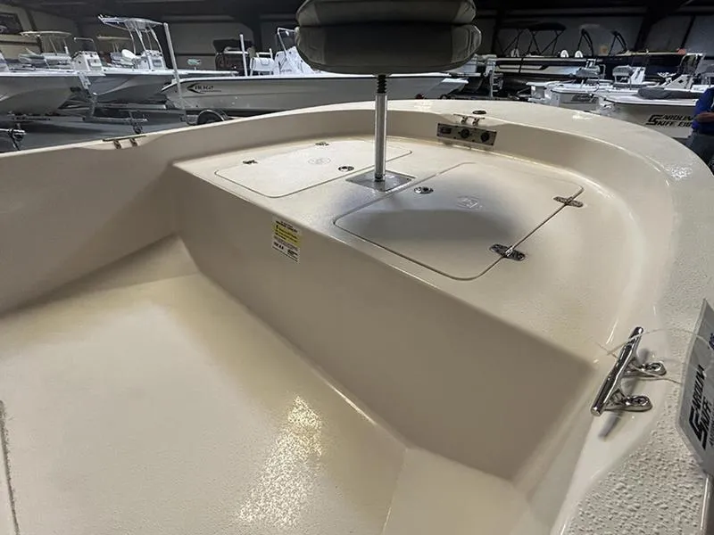 Slide: The Image of 2024 Carolina Skiff 192 JLS boat interior with seating and storage compartments. - 5