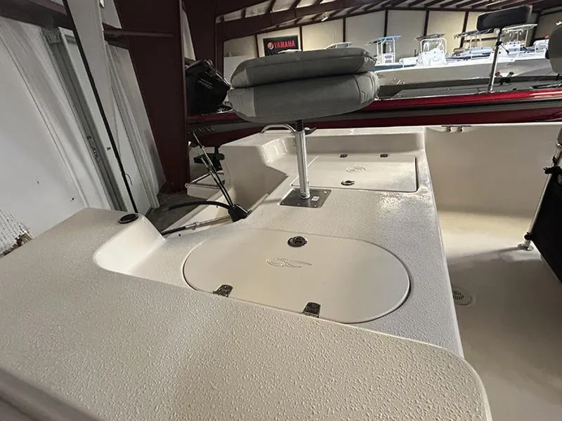 Slide: The Image of 2024 Carolina Skiff 192 JLS boat interior with seating and storage compartments. - 8