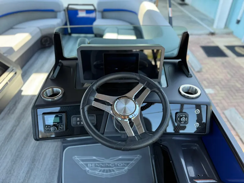 Slide: The Image of 2025 Bennington 24 MFB boat dashboard with steering wheel and modern controls. - 11