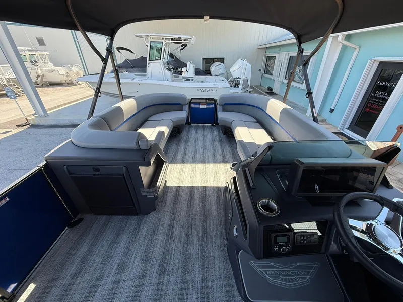 Slide: The Image of 2025 Bennington 24 MFB pontoon boat interior with spacious seating and modern dashboard. - 15
