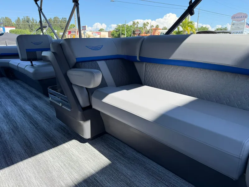 Slide: The Image of 2025 Bennington 24 MFB boat interior with gray and blue seating, modern design. - 21