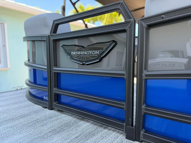 Slide: The Image of 2025 Bennington 24 MFB pontoon boat with sleek blue and gray design. - 3