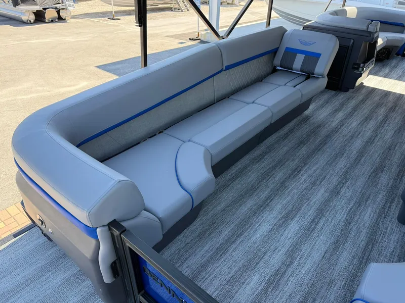 Slide: The Image of 2025 Bennington 24 MFB boat interior with gray and blue seating on a textured floor. - 6