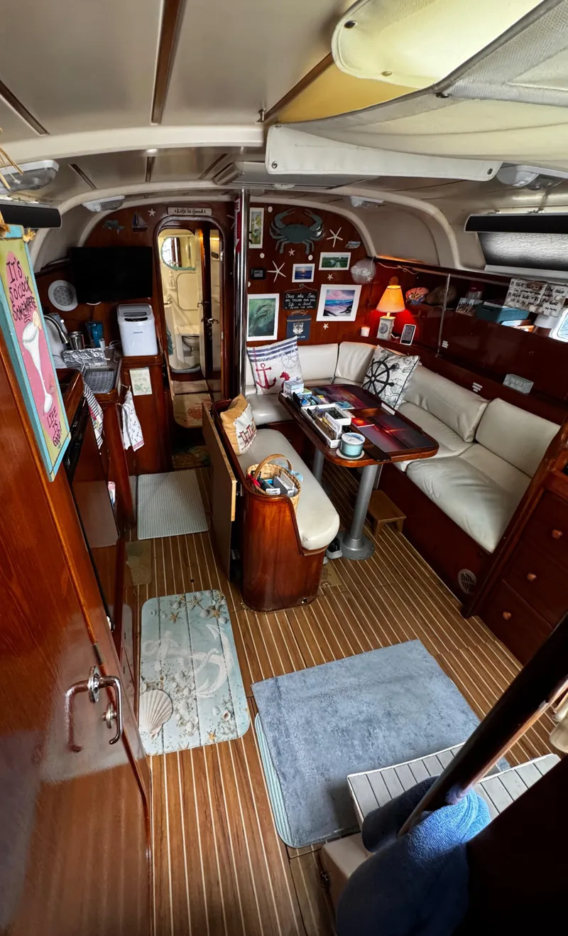 Slide: The Image of V berth with couch and storage, bed on starboard side. Wet head forward of this - 52