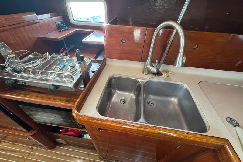 Slide: The Image of Galley kitchen in 1994 Beneteau 40 sailboat with double sink and stove. - 63
