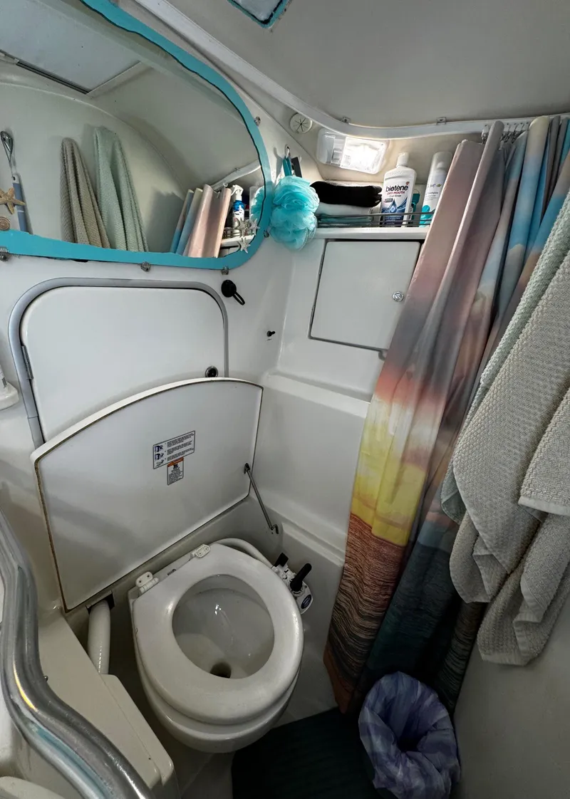 Slide: The Image of Bathroom sink area on a 1994 Beneteau 40 sailboat, featuring faucet and soap dispenser. - 73