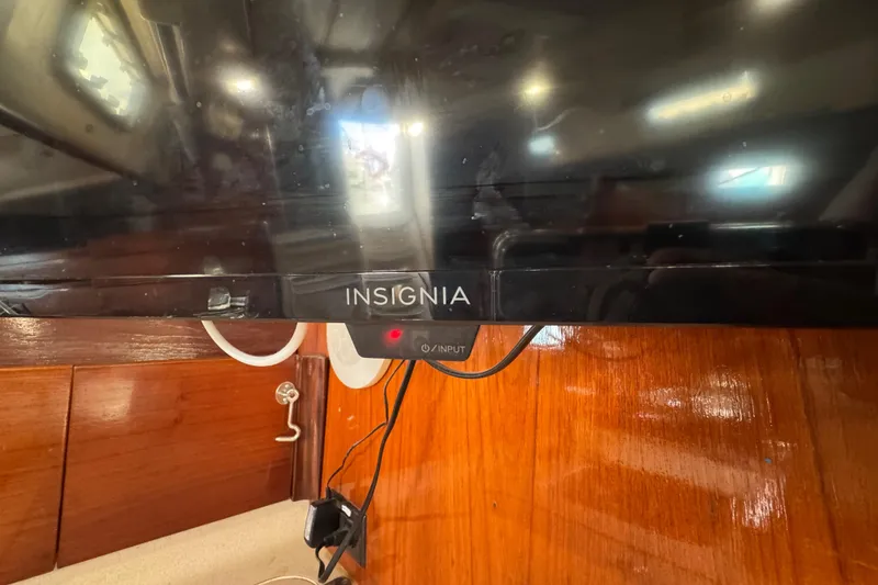 Slide: The Image of Insignia TV mounted on a 1994 Beneteau 40 yacht's wooden interior. - 81