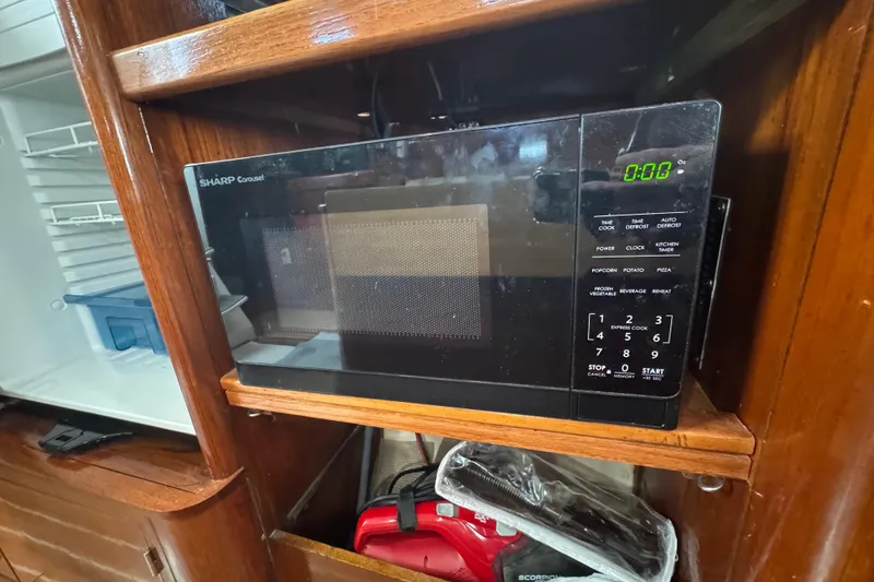 Slide: The Image of Microwave in 1994 Beneteau 40 yacht kitchen with wooden cabinetry. - 86