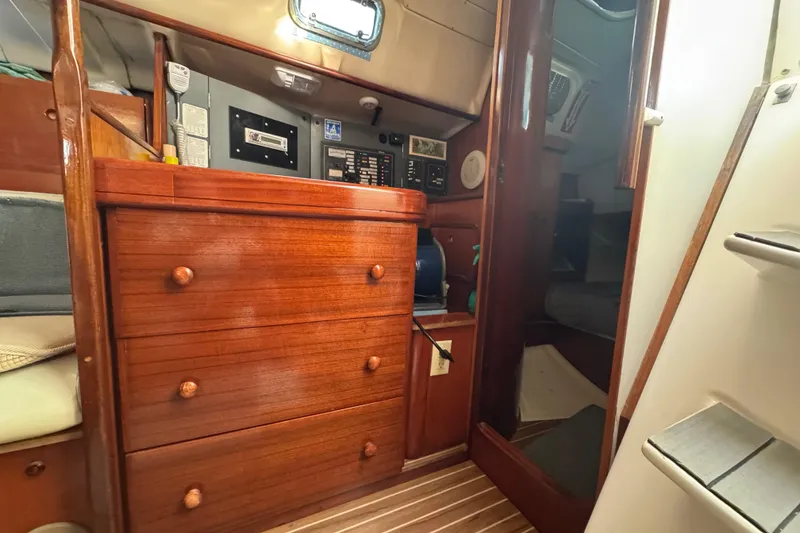 Slide: The Image of Interior of 1994 Beneteau 40 sailboat with wooden cabinetry and control panel. - 93