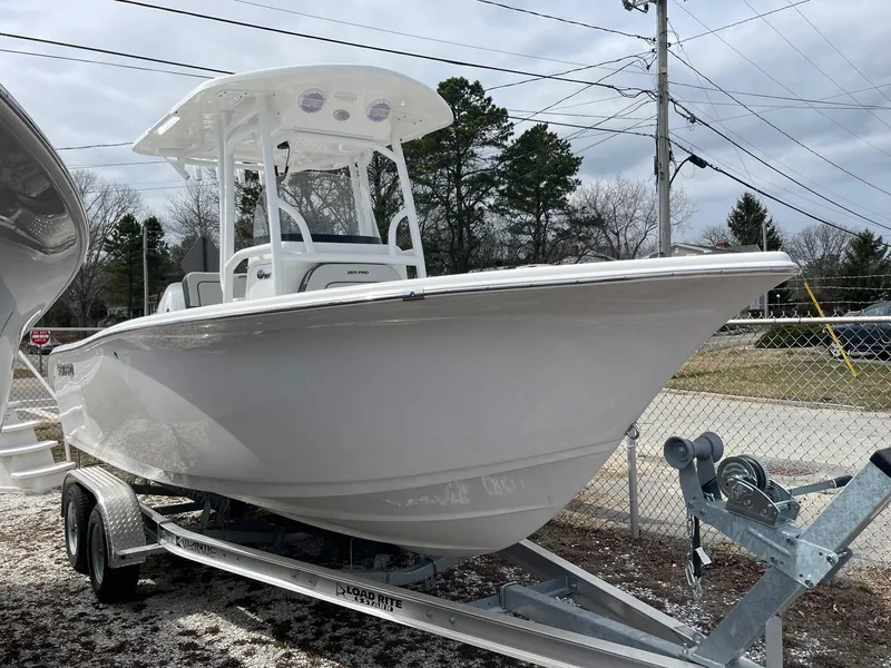 The Image of 2025 Sea Pro 222 Center Console boat on trailer, parked outdoors. - 1