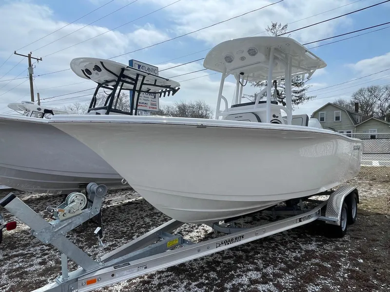 Slide: The Image of 2025 Sea Pro 222 Center Console boat on trailer, displayed outdoors. - 2