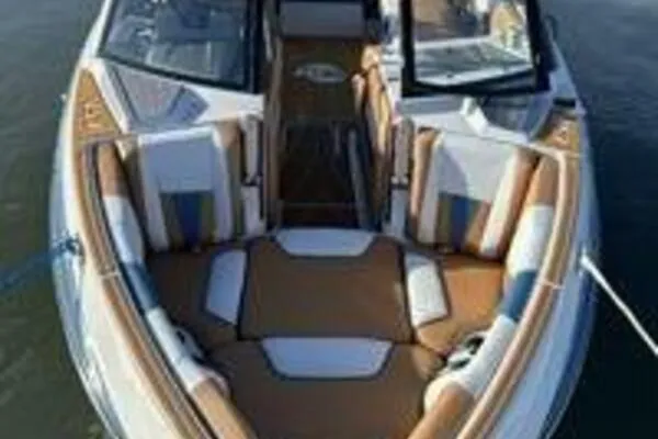 Slide: The Image of 2023 Malibu Wakesetter 23 LSV boat with luxurious seating on calm water. - 5