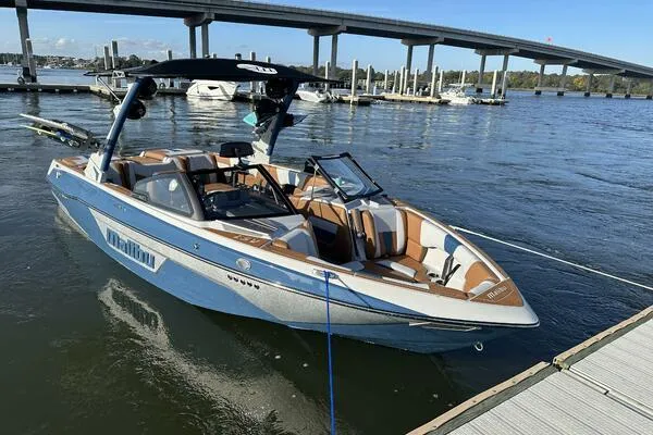 Slide: The Image of 2023 Malibu Wakesetter 23 LSV boat docked on a sunny day. - 9