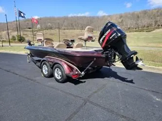 Slide: The Image of 2000 Ranger 520VX boat on trailer with Mercury outboard motor, parked outdoors. - 1