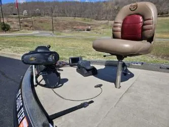 Slide: The Image of 2000 Ranger 520VX boat deck with seat and trolling motor, scenic background. - 11