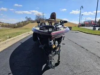 Slide: The Image of 2000 Ranger 520VX boat on trailer, parked on asphalt, under clear blue sky. - 4