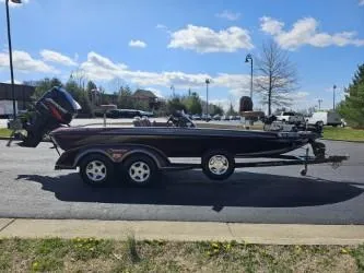 Slide: The Image of 2000 Ranger 520VX boat on trailer, parked outdoors under a blue sky. - 5