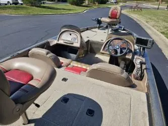 Slide: The Image of 2000 Ranger 520VX boat interior with steering wheel, seats, and dashboard on a sunny day. - 6