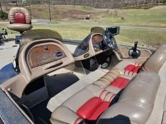 Slide: The Image of 2000 Ranger 520VX boat interior with tan and red seating, steering wheel, and control panel. - 7