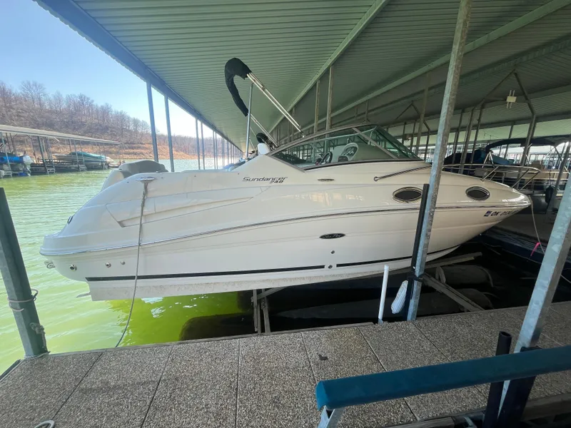 Slide: The Image of 2014 Sea Ray 240 Sundancer docked under a covered marina. - 0