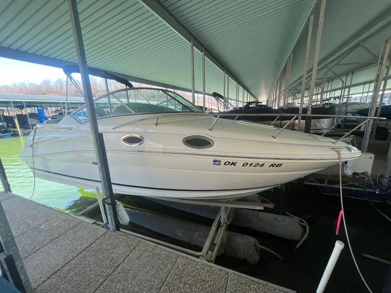 Slide: The Image of 2014 Sea Ray 240 Sundancer docked in a covered marina. - 1