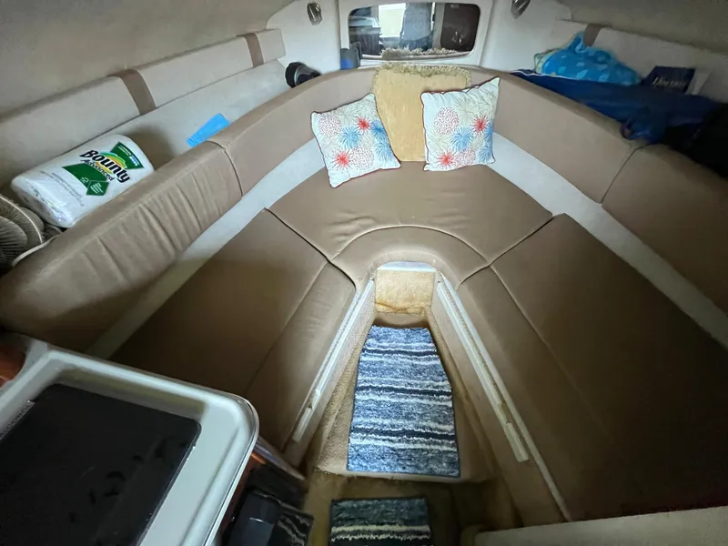 Slide: The Image of Interior of 2014 Sea Ray 240 Sundancer with cozy seating and decorative pillows. - 11