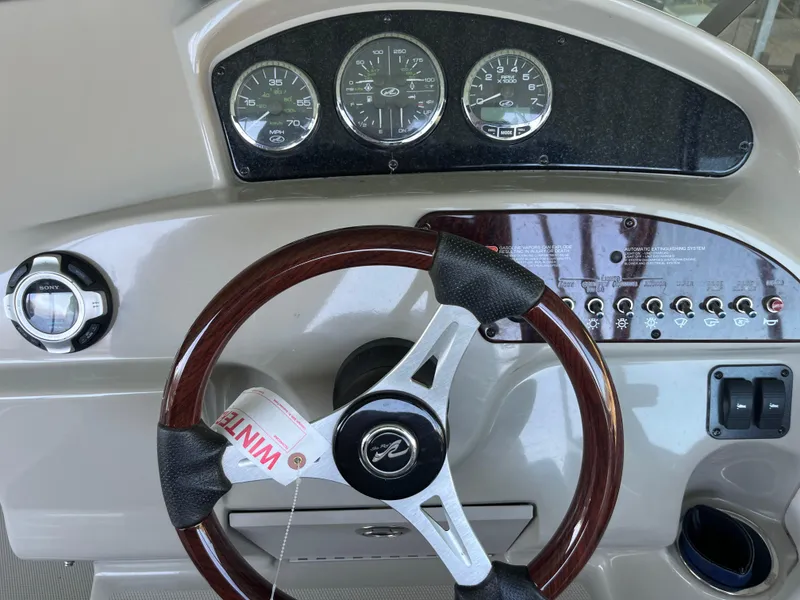 Slide: The Image of Steering wheel and dashboard of 2014 Sea Ray 240 Sundancer boat. - 18