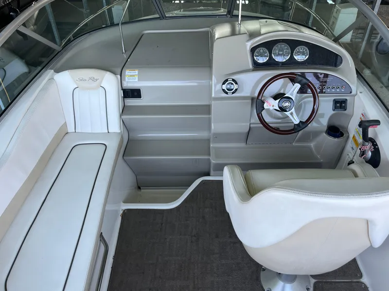 Slide: The Image of 2014 Sea Ray 240 Sundancer boat interior with helm and seating area. - 20