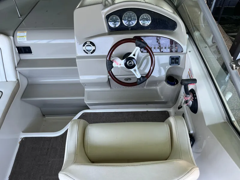 Slide: The Image of 2014 Sea Ray 240 Sundancer helm with steering wheel and instrument panel. - 21