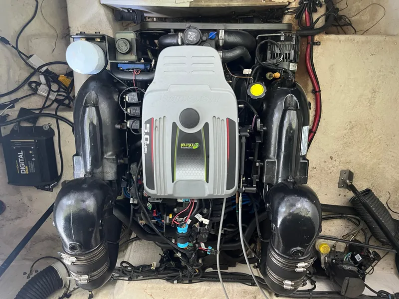 Slide: The Image of Engine of 2014 Sea Ray 240 Sundancer boat, showcasing detailed components and layout. - 24