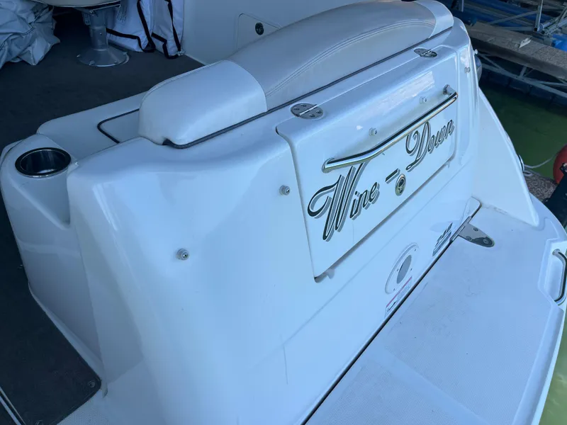 Slide: The Image of 2014 Sea Ray 240 Sundancer boat with custom nameplate on the stern. - 25