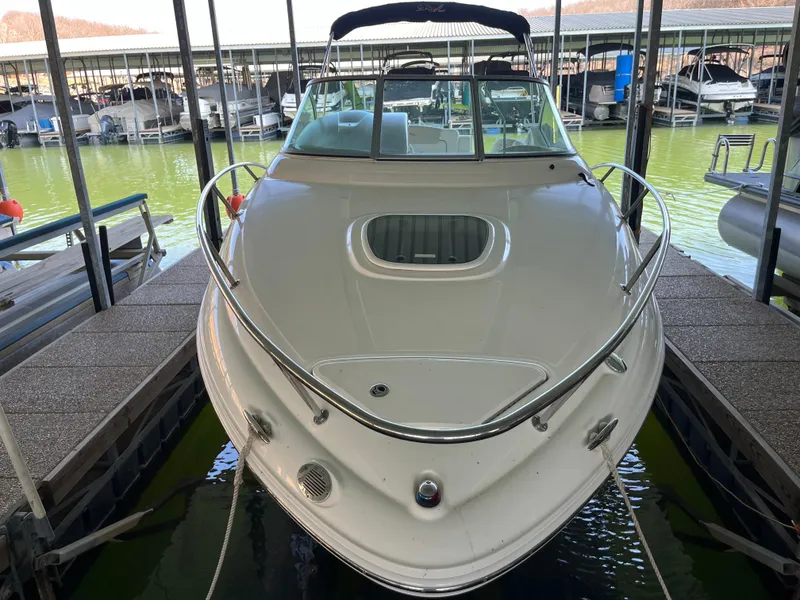 Slide: The Image of 2014 Sea Ray 240 Sundancer docked in a marina, front view. - 6