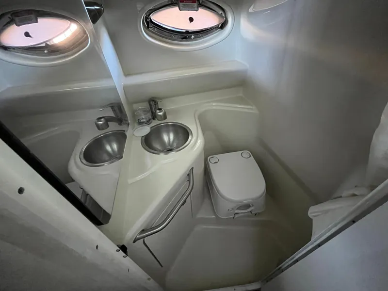 Slide: The Image of Compact bathroom in 2014 Sea Ray 240 Sundancer boat with sink and toilet. - 8