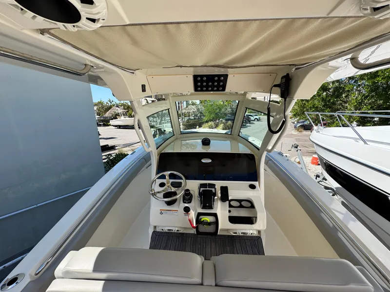 Slide: The Image of 2023 Scout 305 LXF boat cockpit with steering wheel and control panel. - 10