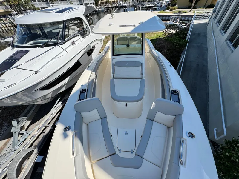 Slide: The Image of 2023 Scout 305 LXF boat with sleek design and spacious seating. - 15