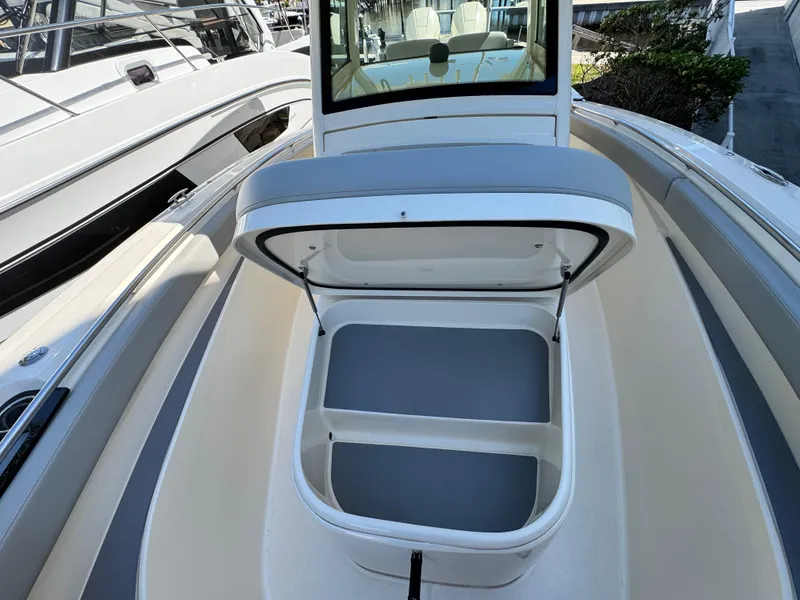 Slide: The Image of 2023 Scout 305 LXF boat with open storage compartment on deck. - 17