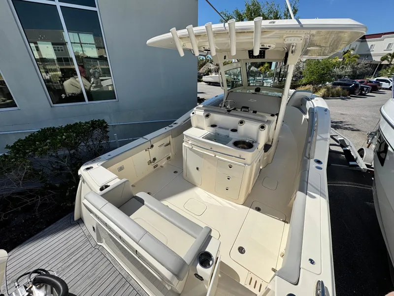 Slide: The Image of 2023 Scout 305 LXF boat with spacious deck and modern amenities. - 7