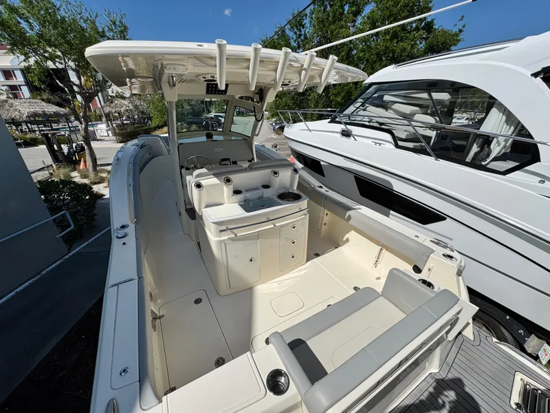 Slide: The Image of 2023 Scout 305 LXF boat with spacious deck and seating area. - 8