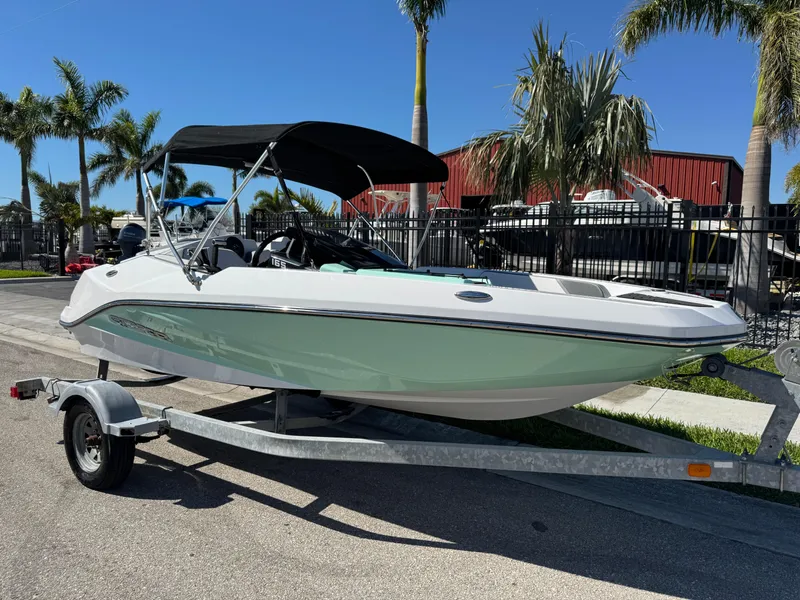 The Image of 2022 Scarab 165 ID boat on trailer, parked near palm trees. - 0