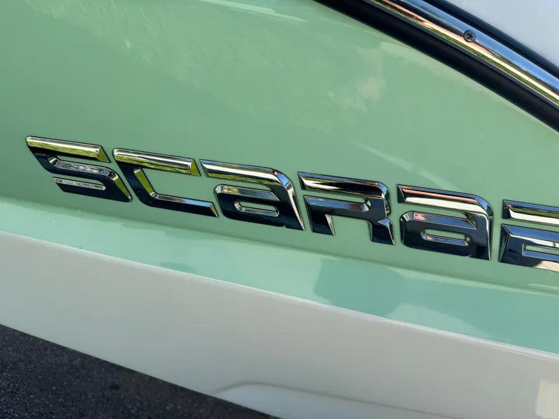 Slide: The Image of 2022 Scarab 165 ID boat logo on a light green surface. - 11