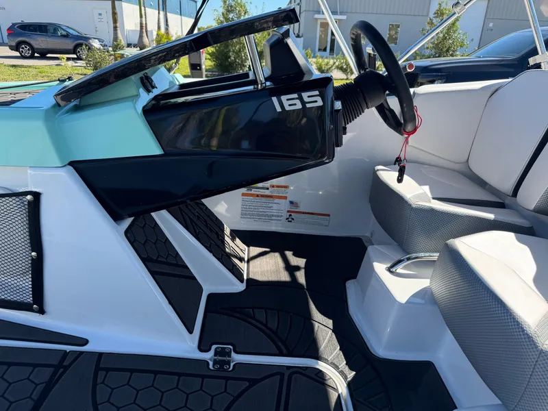 Slide: The Image of 2022 Scarab 165 ID boat interior with steering wheel and seating. - 17