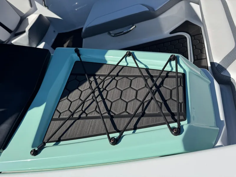 Slide: The Image of 2022 Scarab 165 ID boat interior with hexagonal pattern and teal accents. - 21