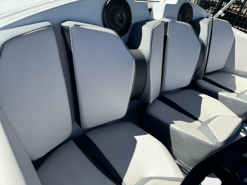 Slide: The Image of 2022 Scarab 165 ID boat interior with gray cushioned seats and speakers. - 24